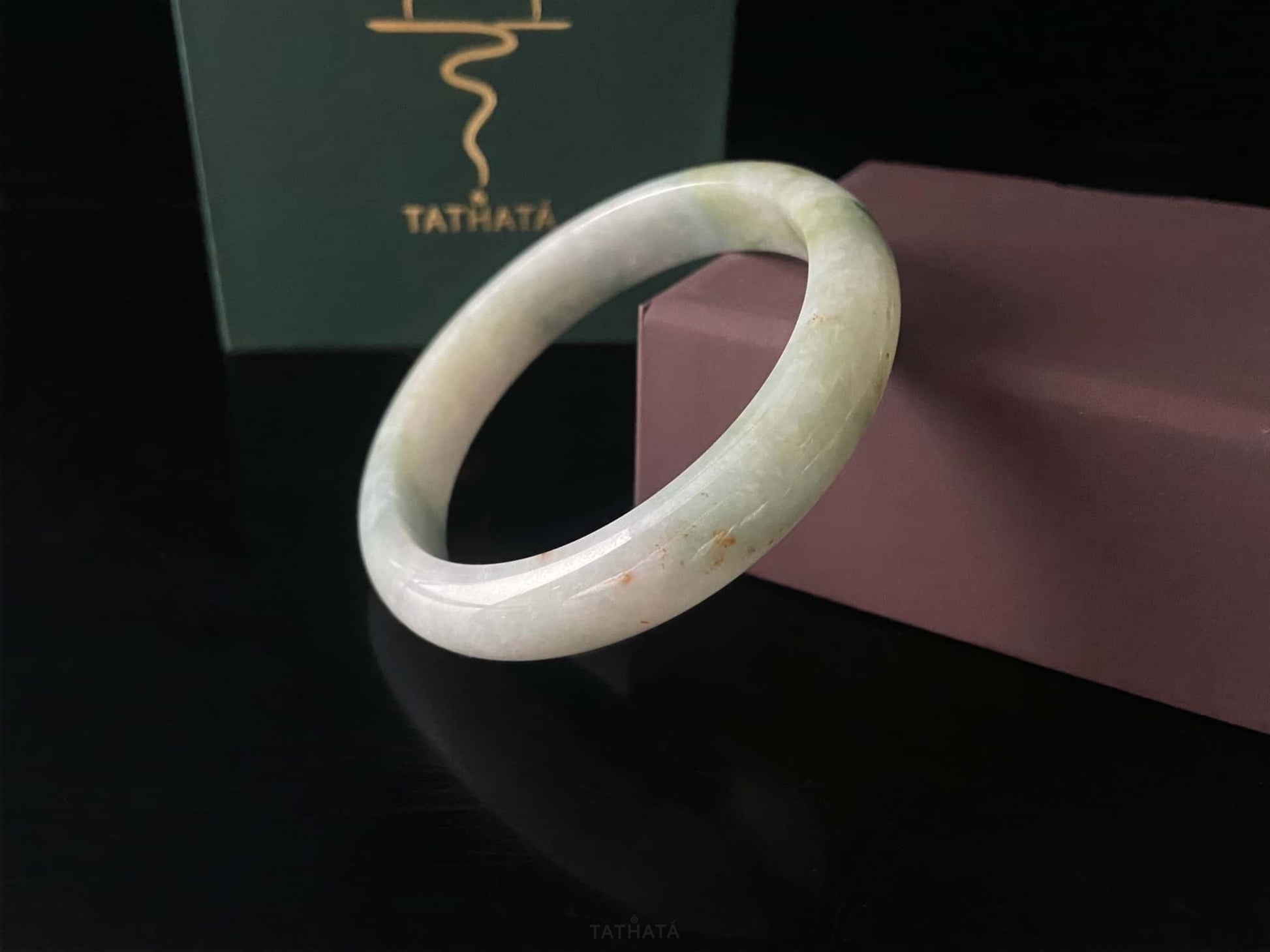 A milky mint honey spot jadeite bangle.