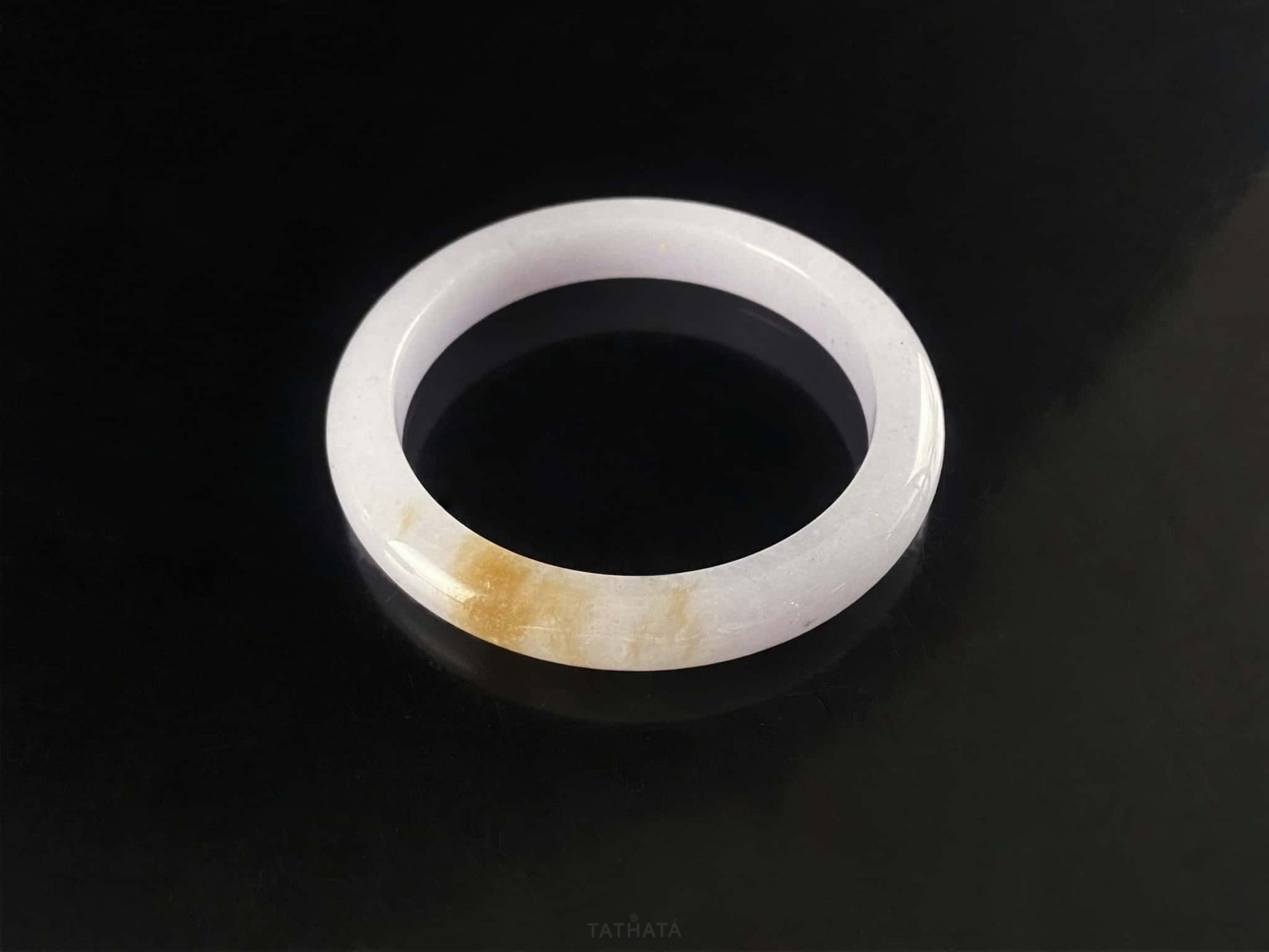 A lavender golden tip jadeite bangle.