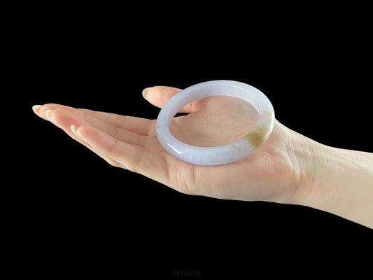 A lavender golden tip jadeite bangle.