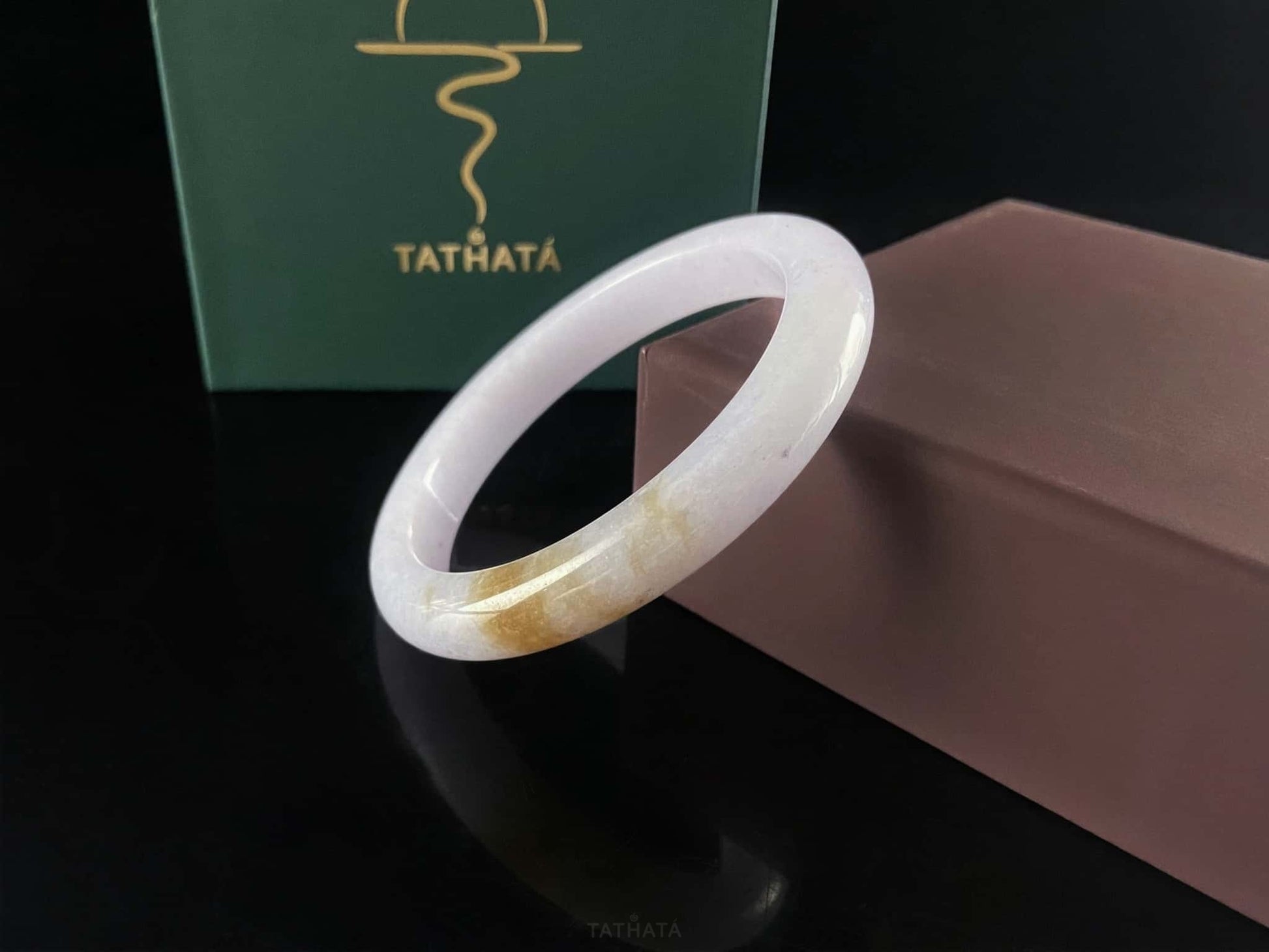 A lavender golden tip jadeite bangle.