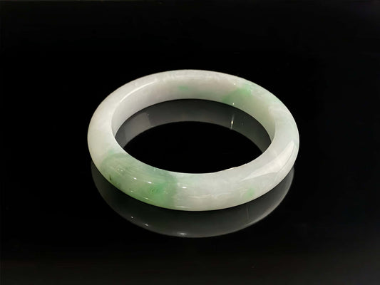 A cloud white and floating green jadeite bangle.