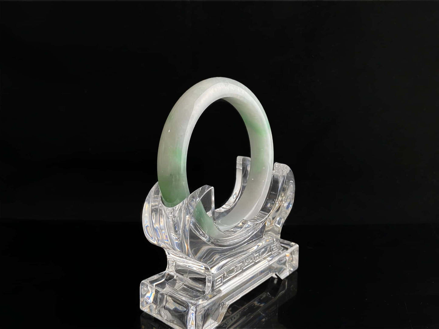 A cloud white and floating green jadeite bangle.