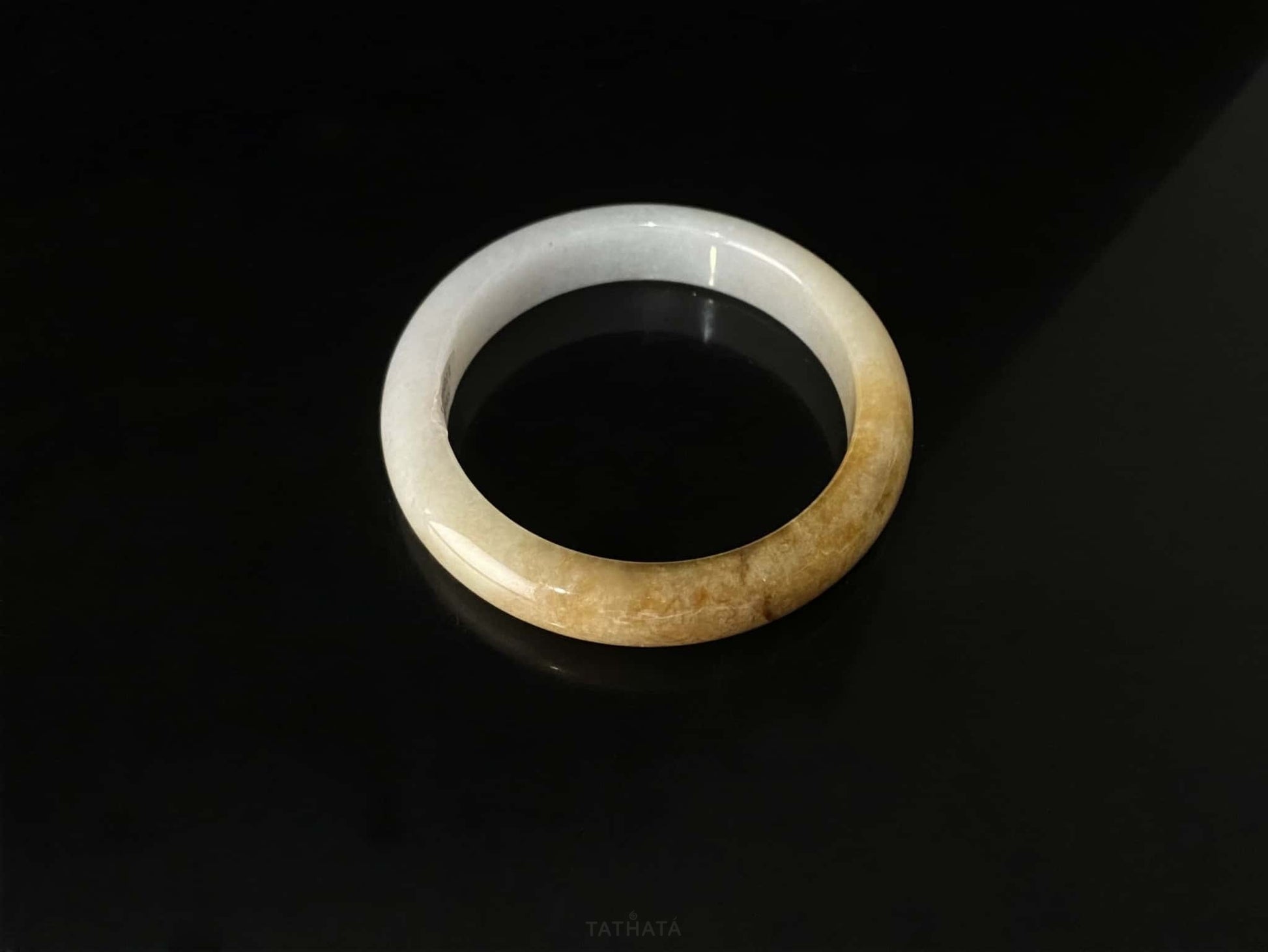 A sundrop amber glow jadeite bangle.