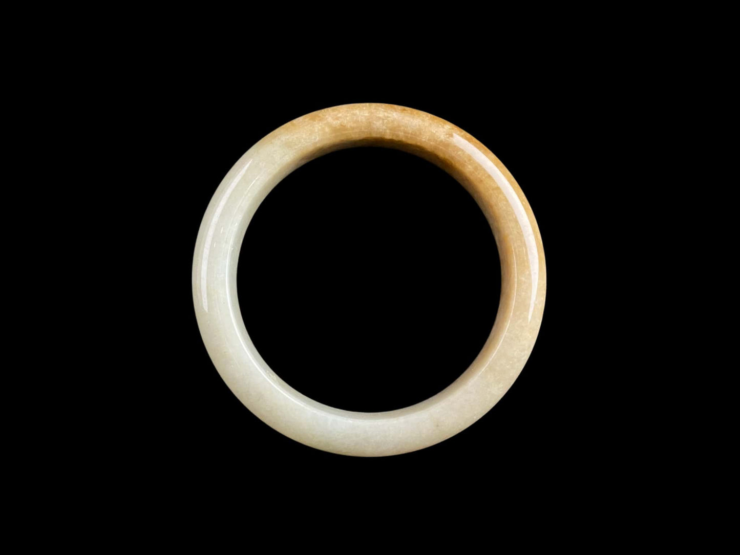 A cream honey gradient jadeite bangle.