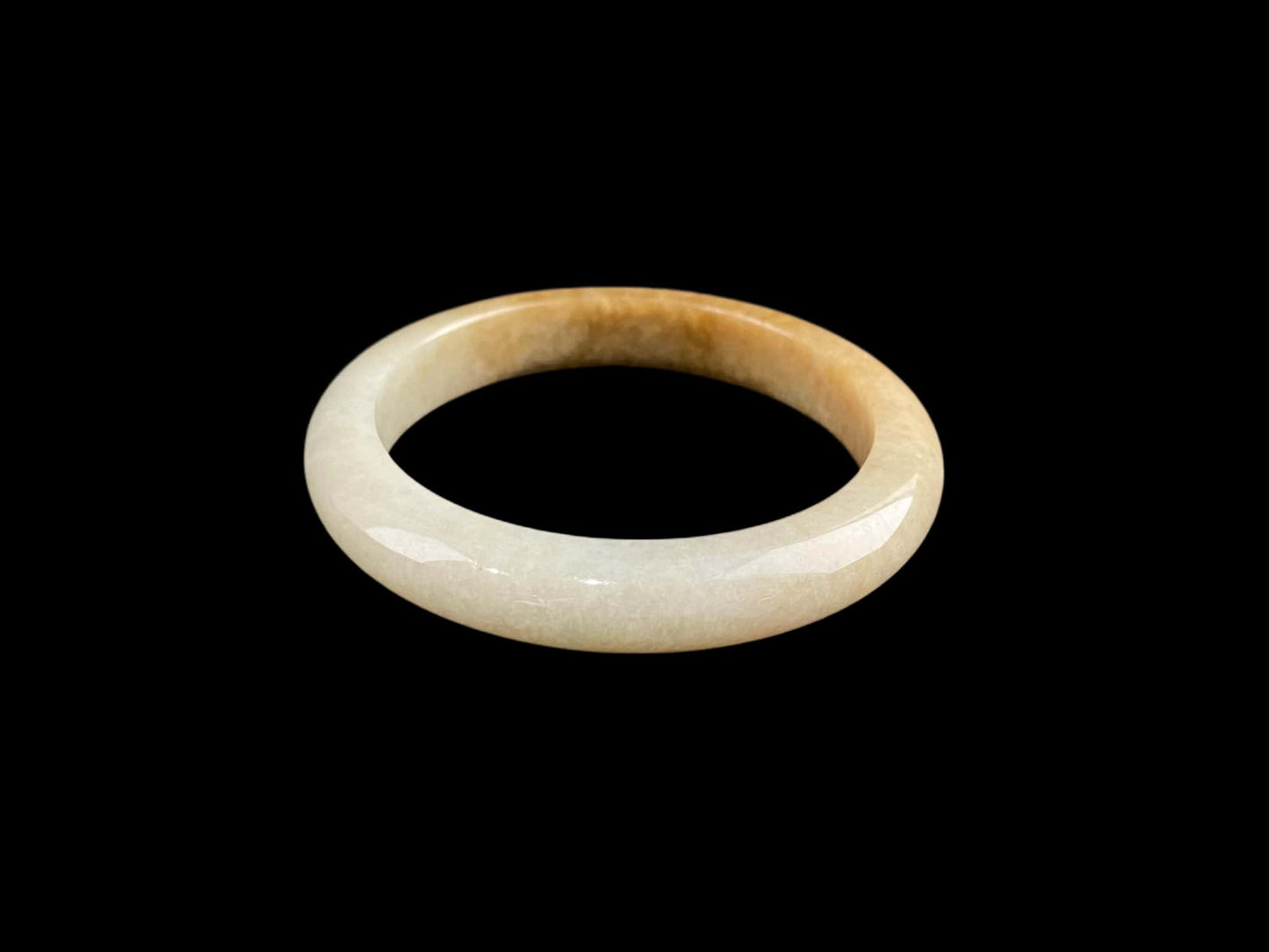 A cream honey gradient jadeite bangle.