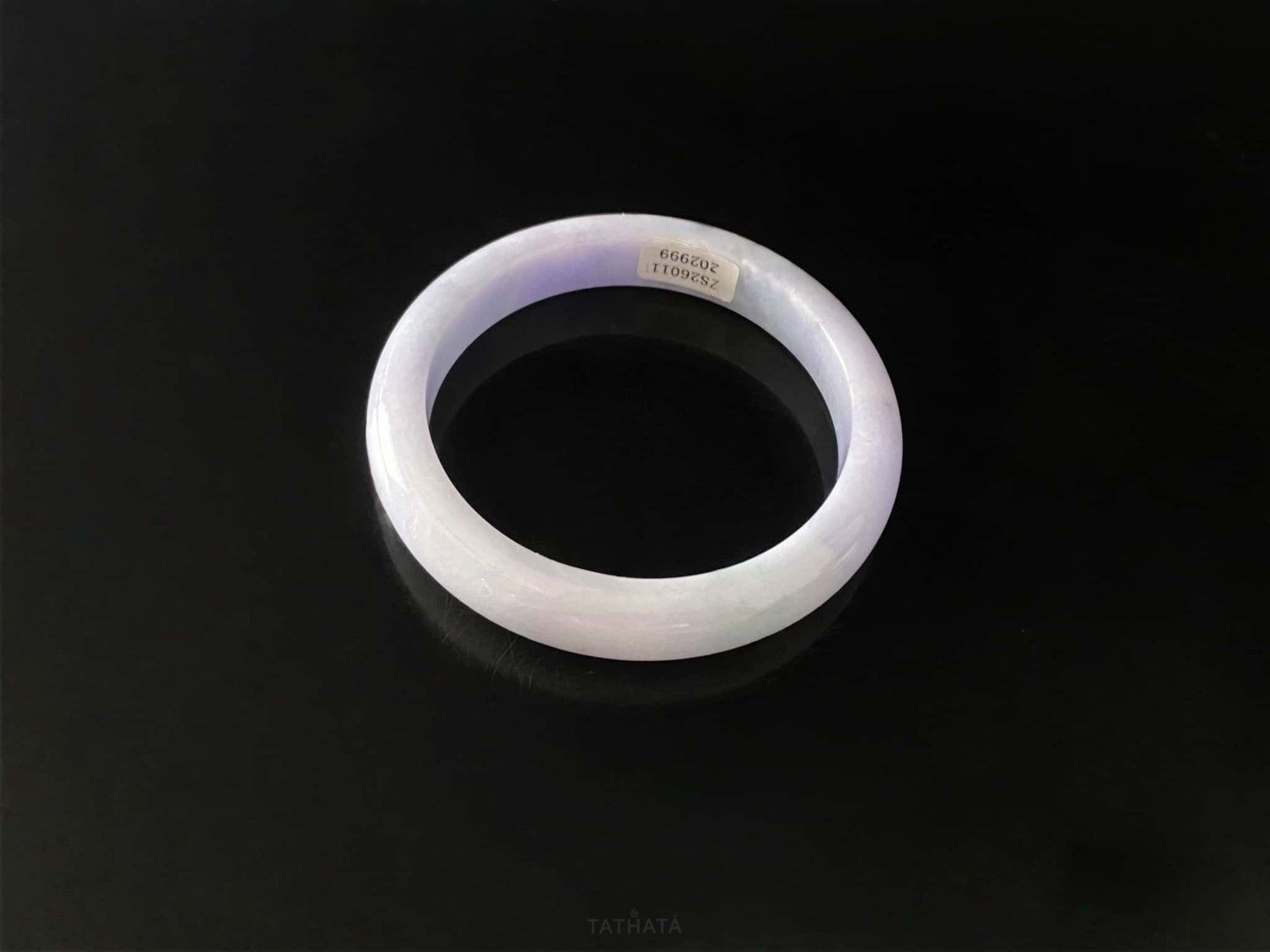 A lavender green streak jadeite bangle.