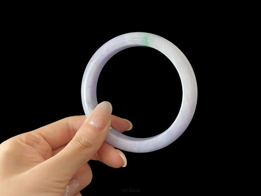 A lavender green streak jadeite bangle.