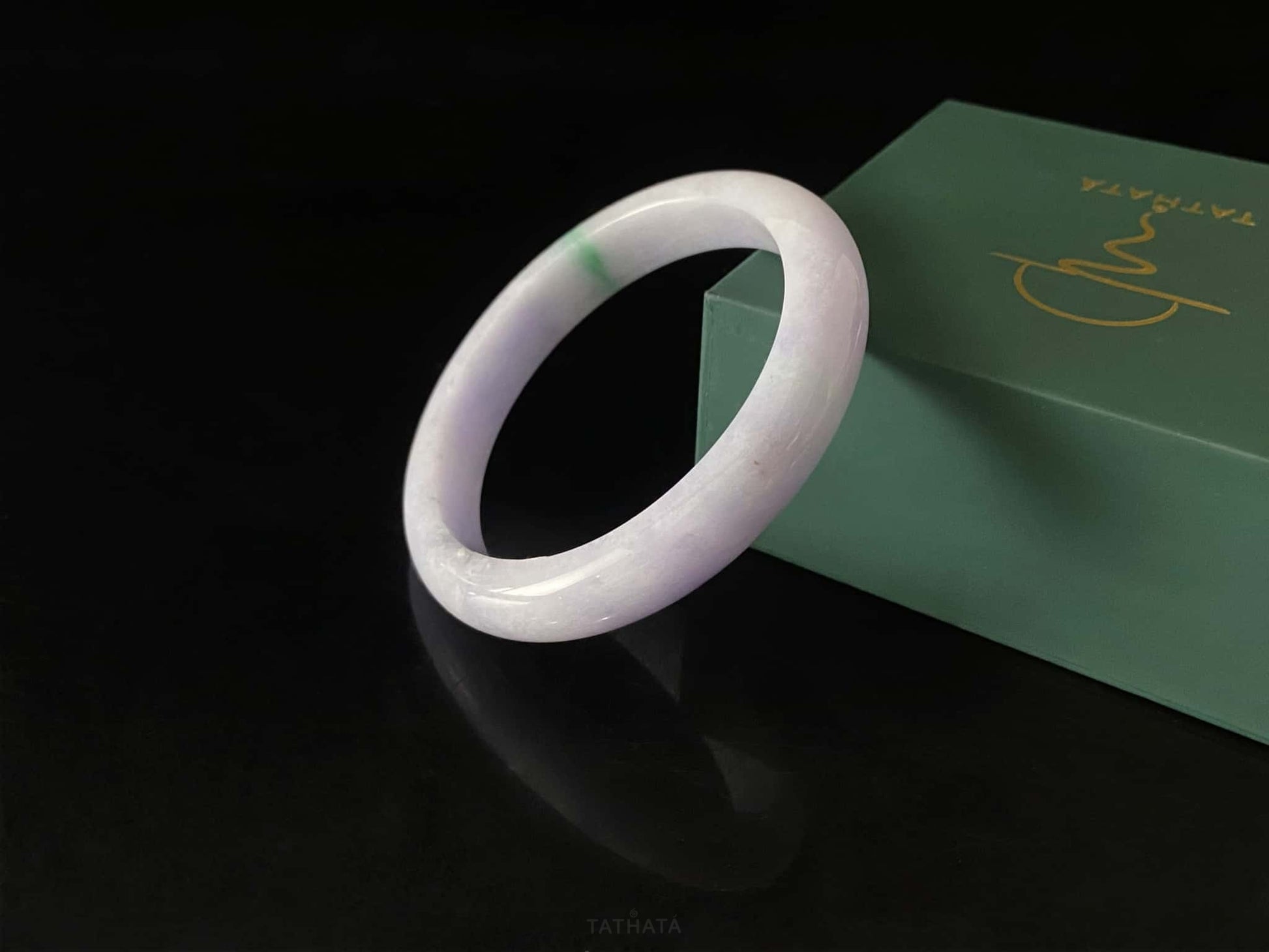 A lavender green streak jadeite bangle.