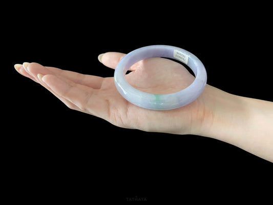 A lavender green streak jadeite bangle.