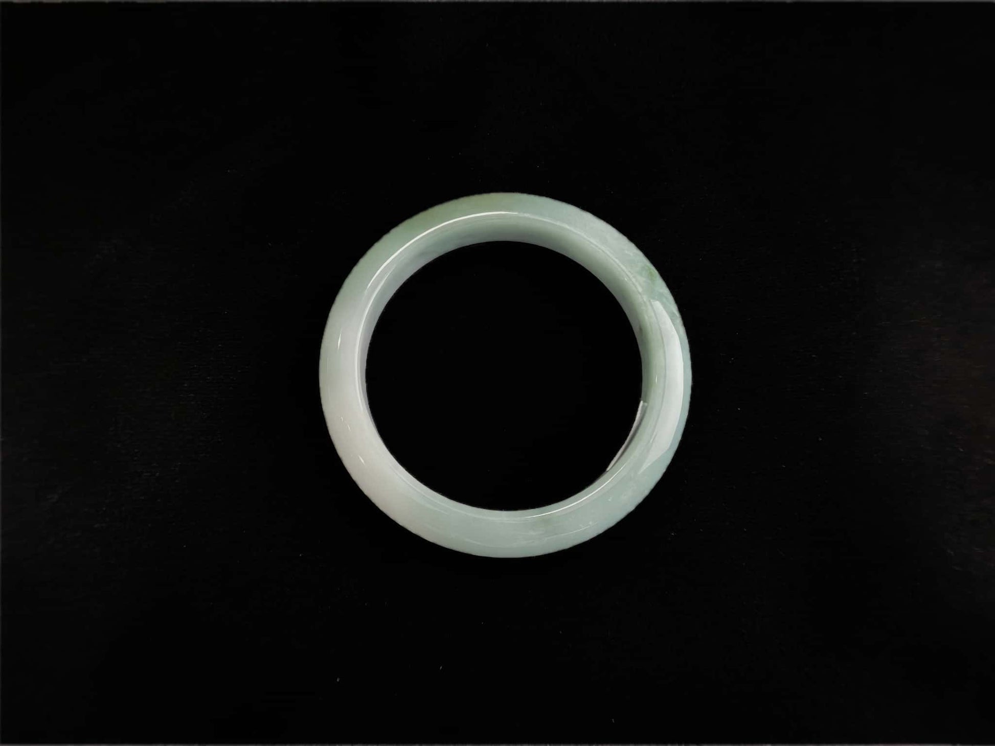 A white base mint green veil jadeite bangle.