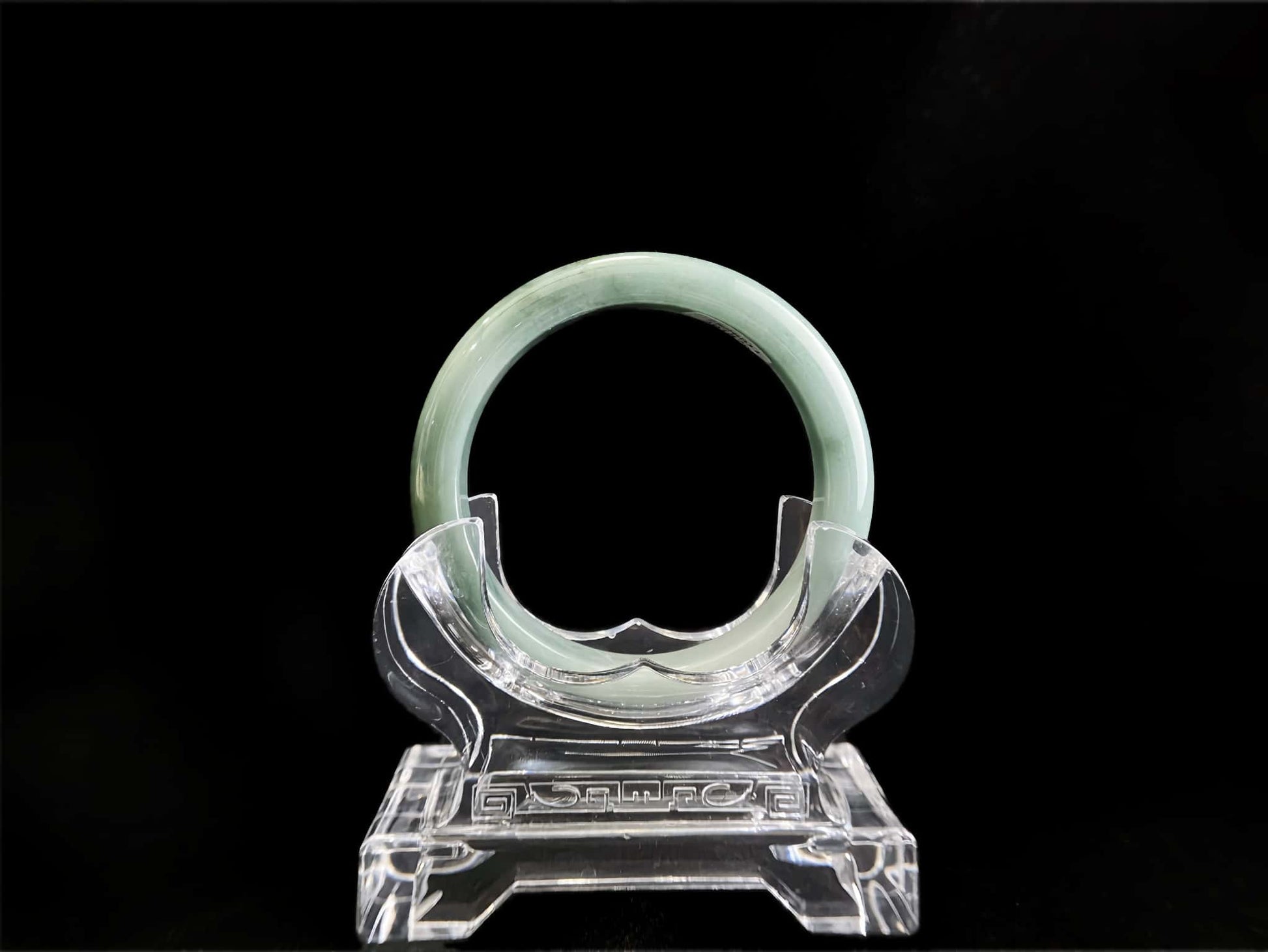 A white base mint green veil jadeite bangle.