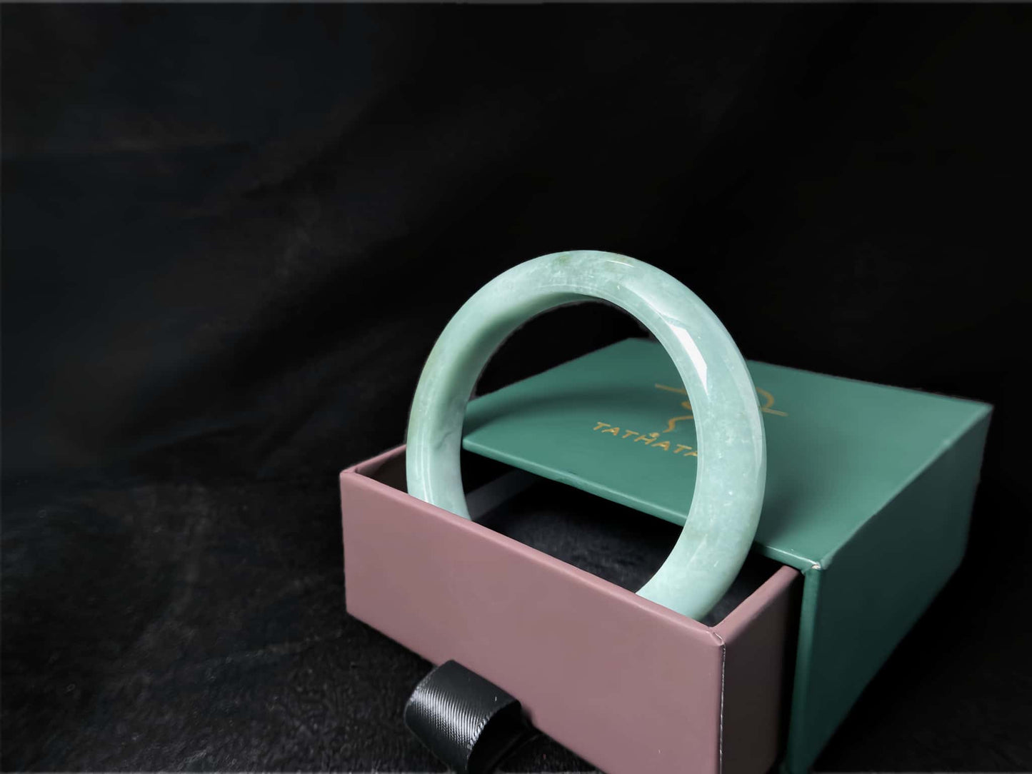 A white base mint green veil jadeite bangle.
