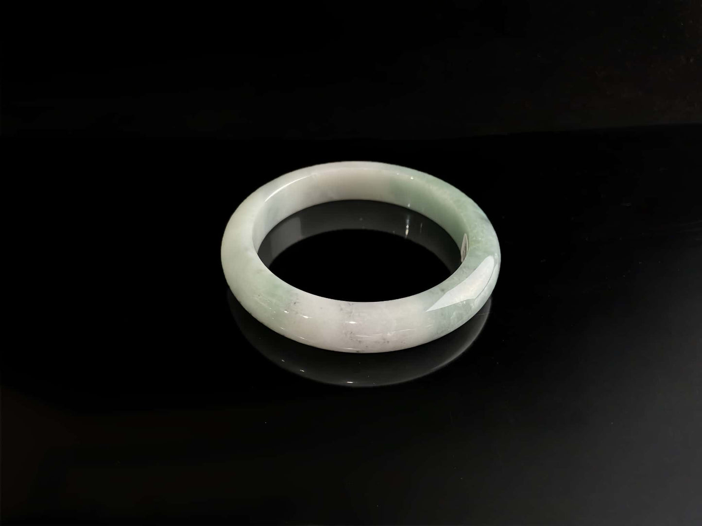 A milky white with faint green jadeite bangle.