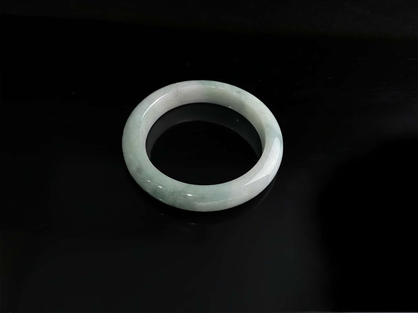 A milky white with faint green jadeite bangle.