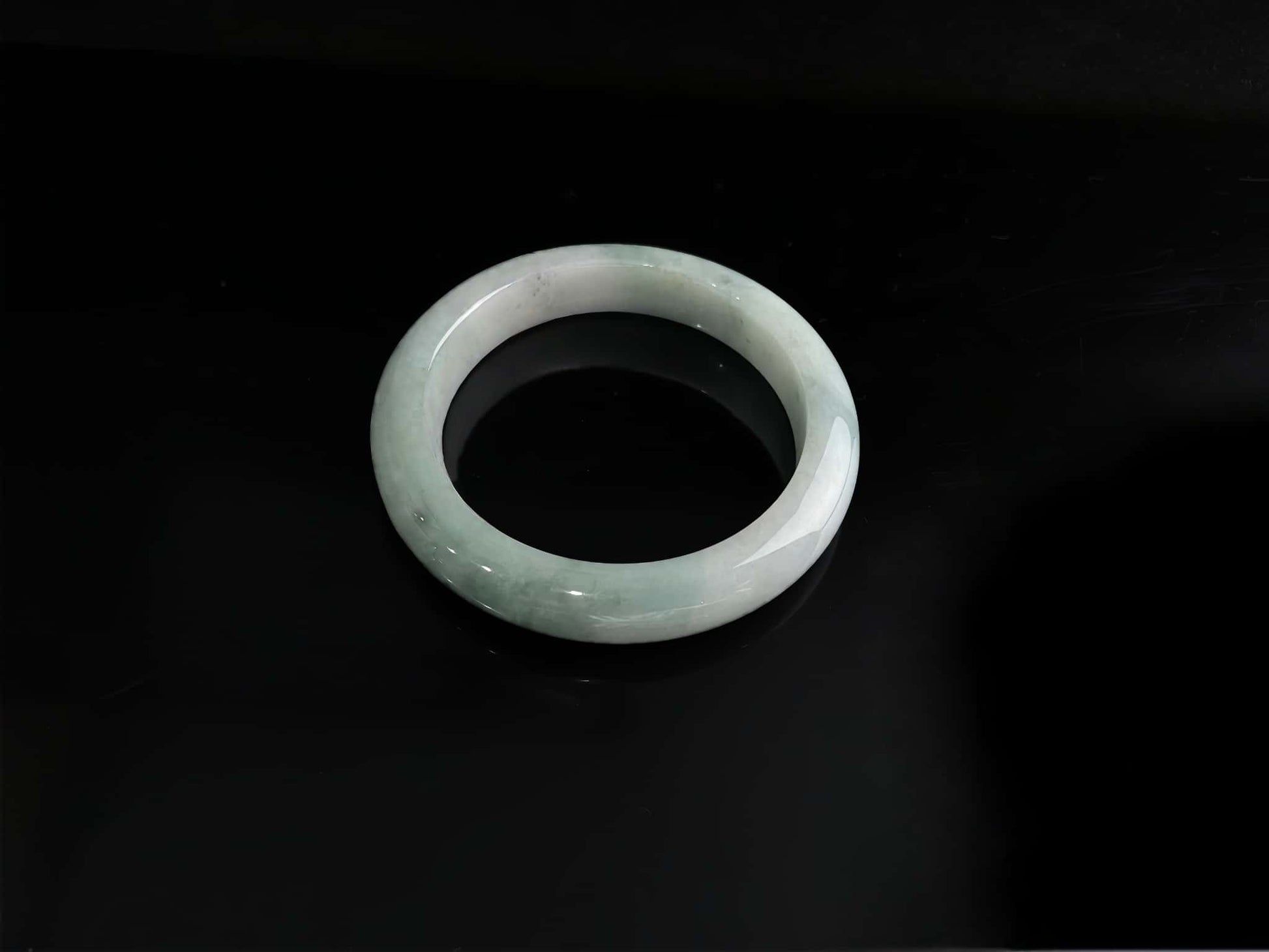 A milky white with faint green jadeite bangle.