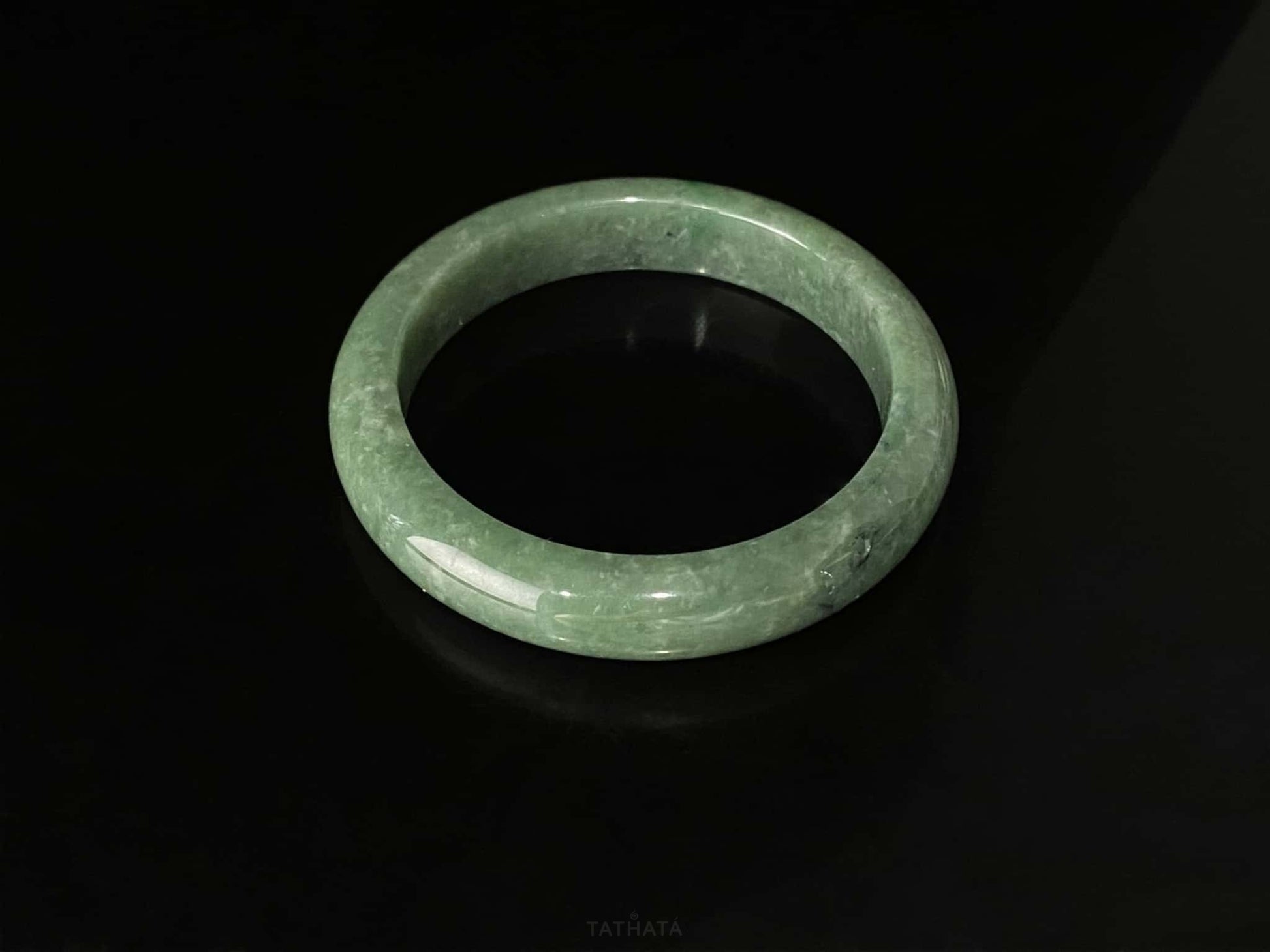 A grass green veil jadeite bangle.