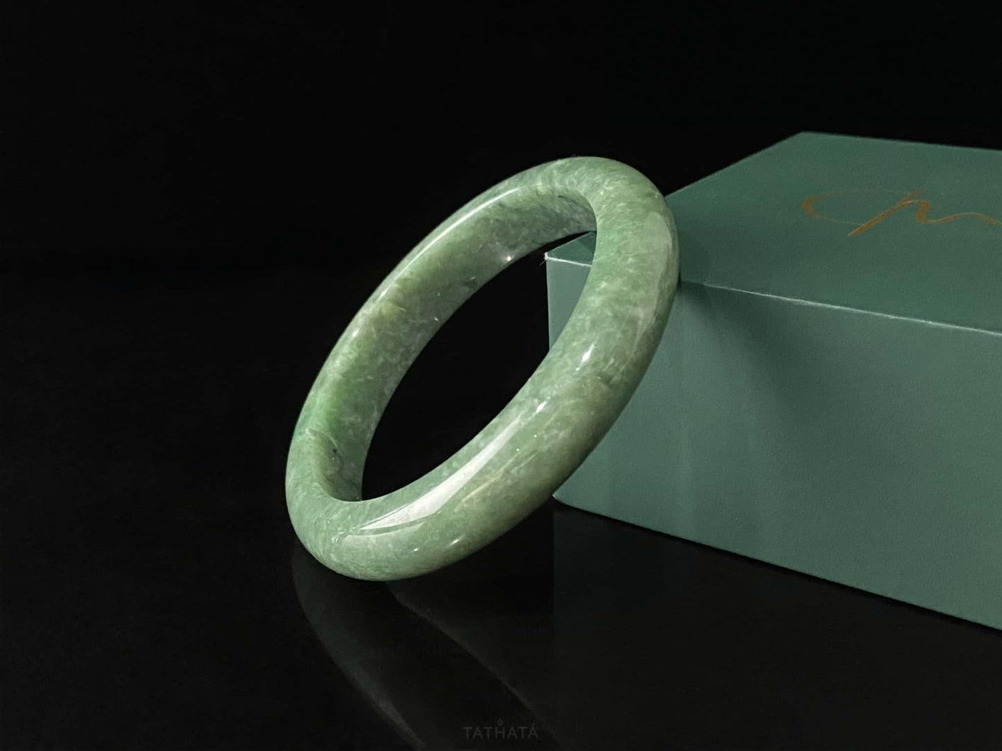 A grass green veil jadeite bangle.