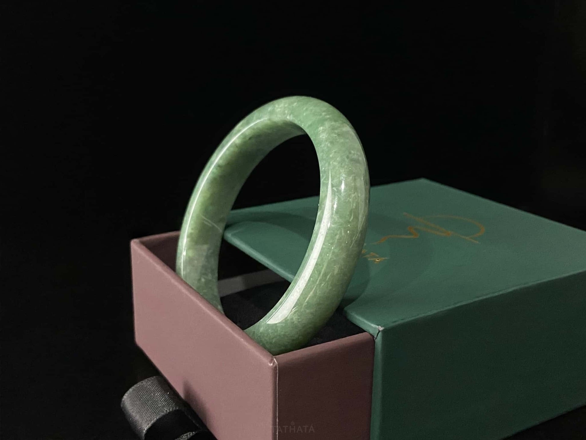 A grass green veil jadeite bangle.