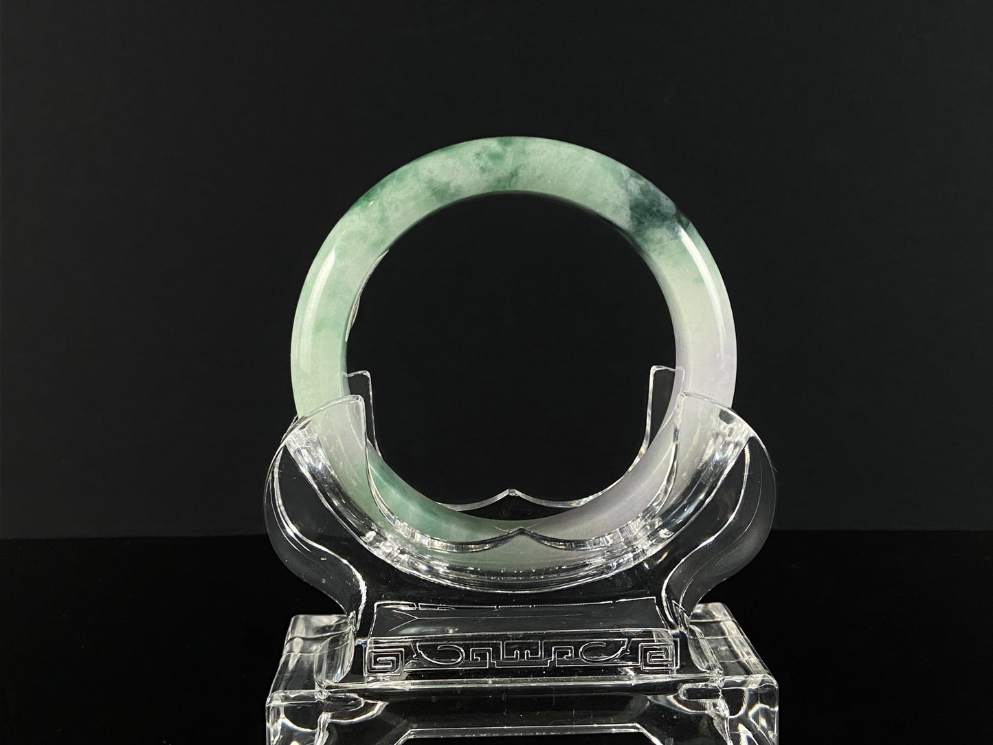 A soft lavender with green swirl jadeite bangle.