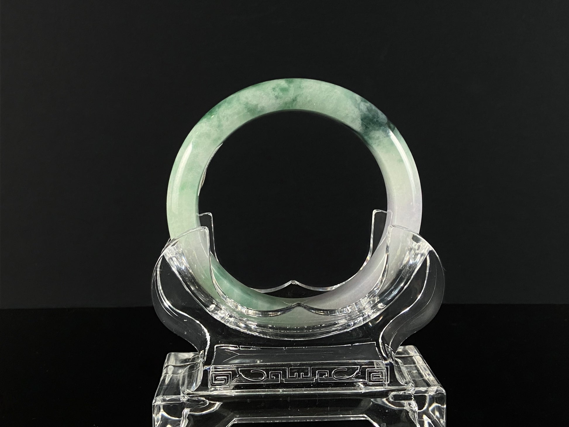 A soft lavender with green swirl jadeite bangle.