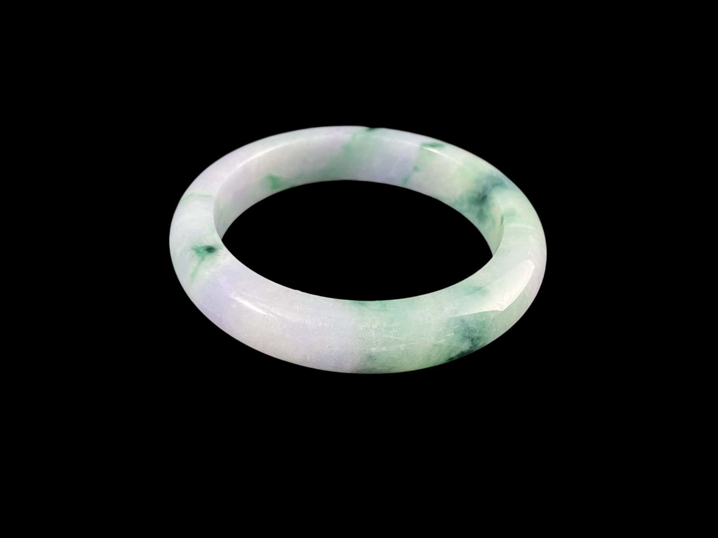 A lilac cloud with floating green jadeite bangle.