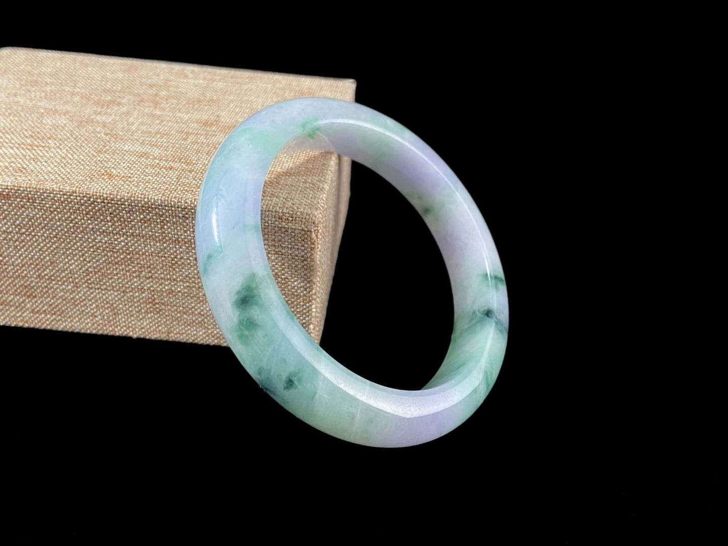A lilac cloud with floating green jadeite bangle.