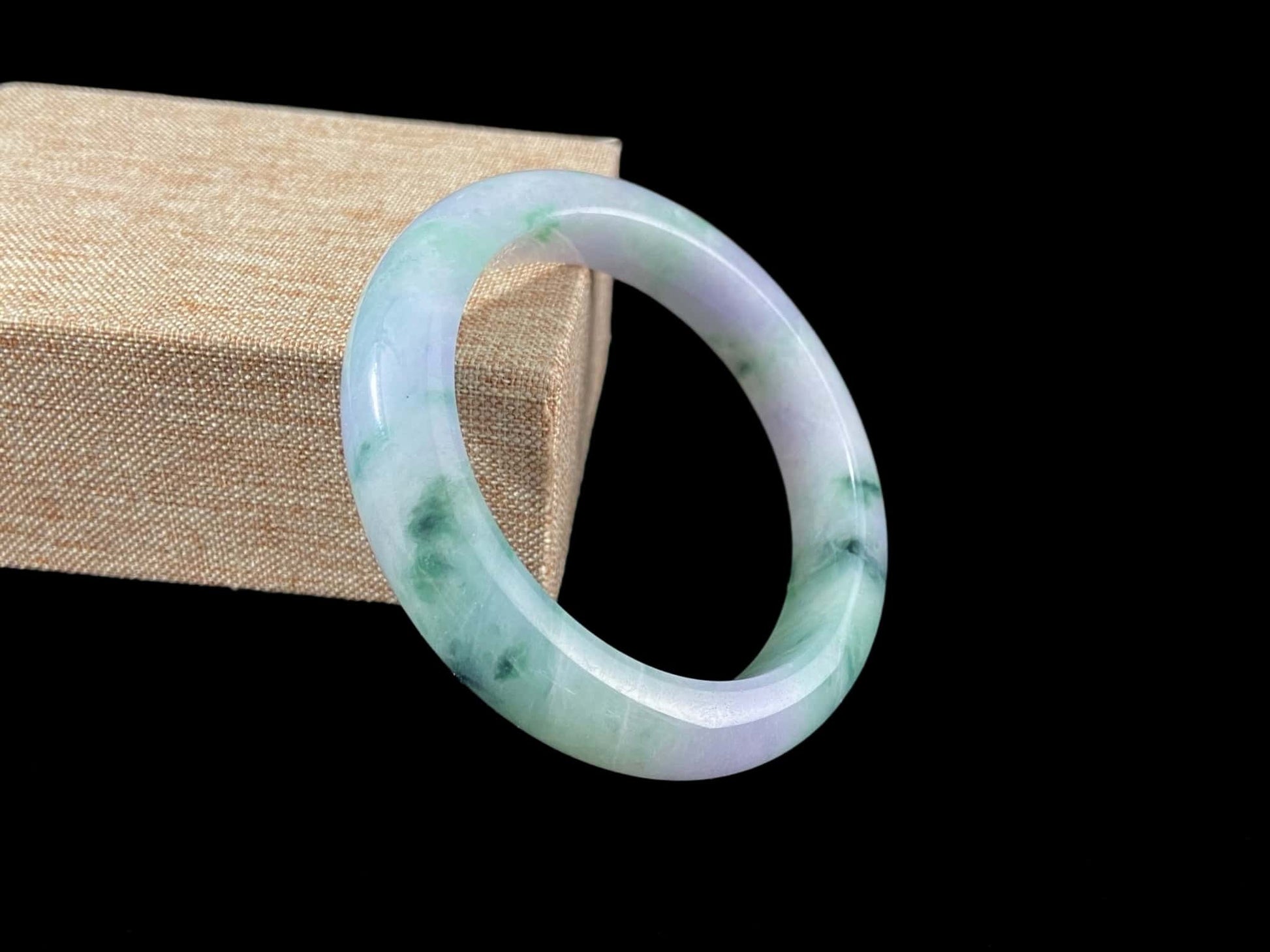 A lilac cloud with floating green jadeite bangle.