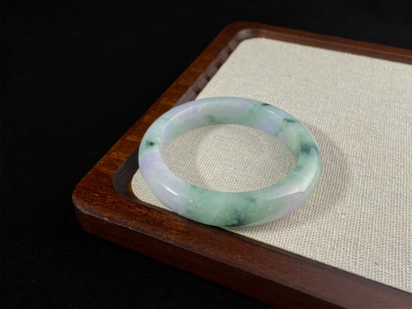 A lilac cloud with floating green jadeite bangle.