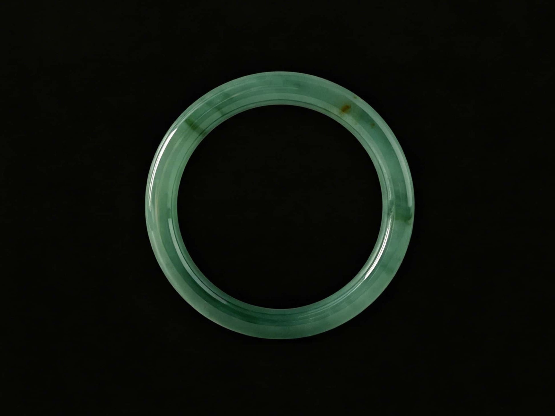 A honey green mist jadeite bangle.