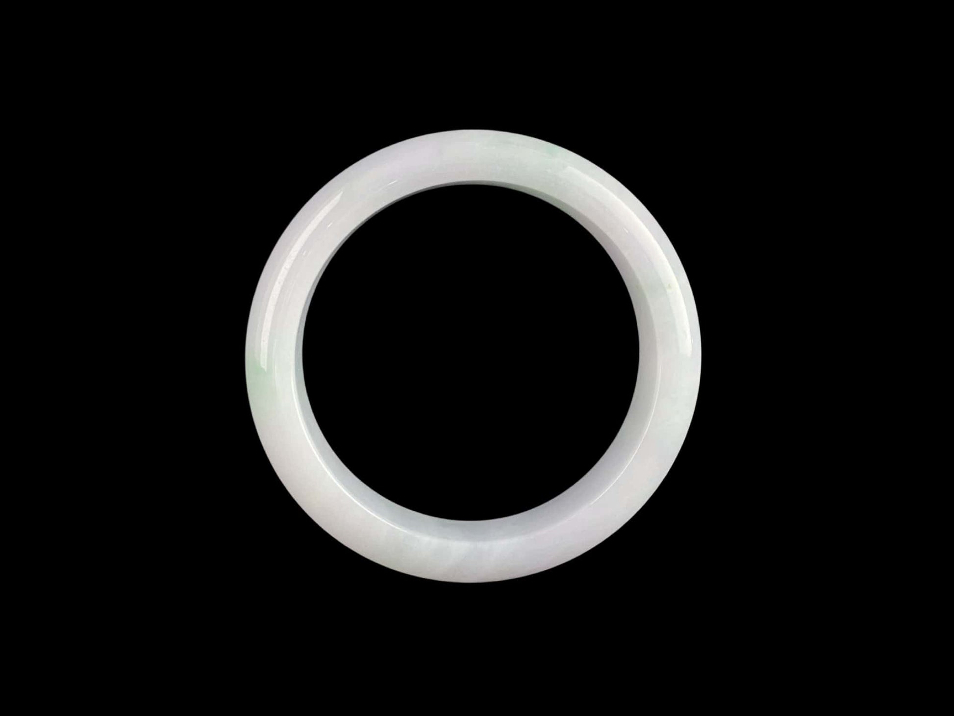 A pristine white with green veil jadeite bangle.