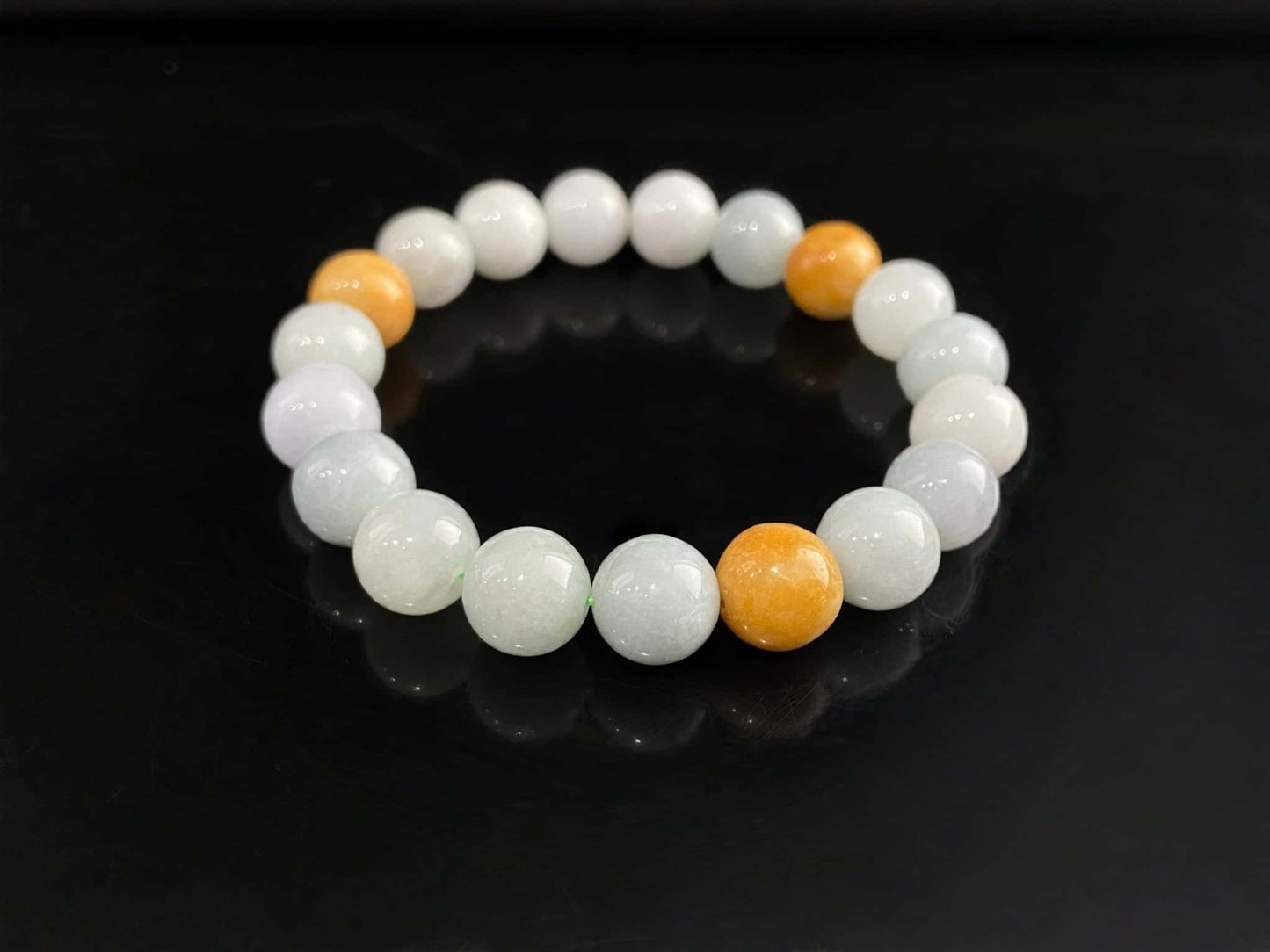 A four hues harmony jadeite beads bracelet.