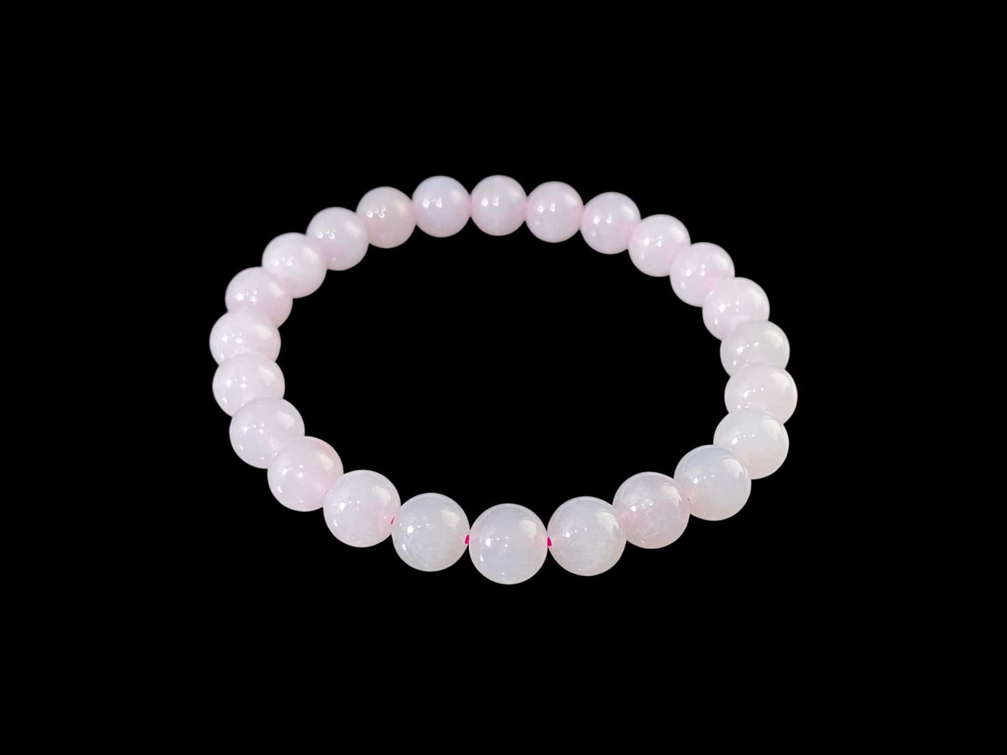 A clear white with pink thread jadeite beads bracelet.