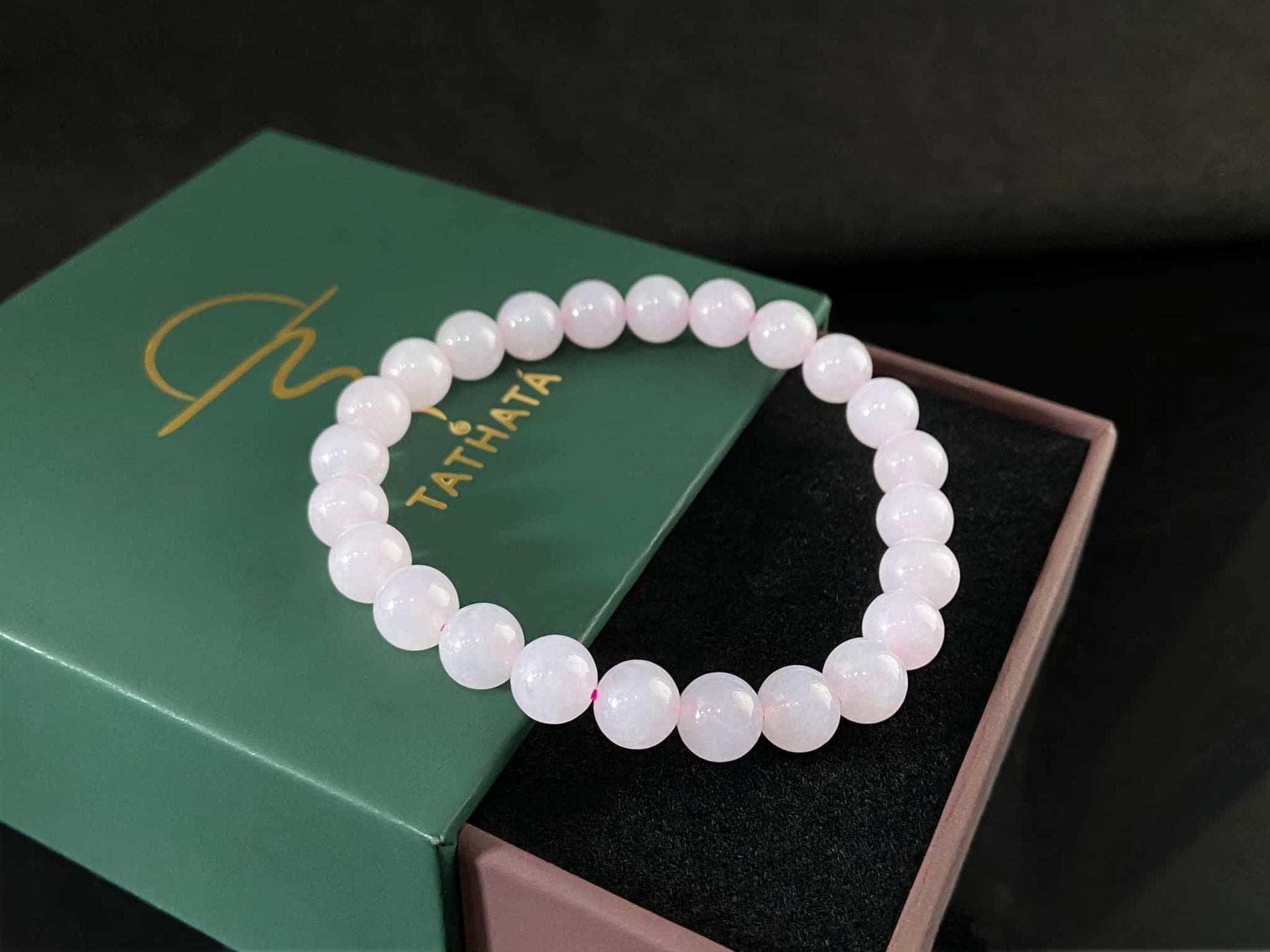 A clear white with pink thread jadeite beads bracelet.