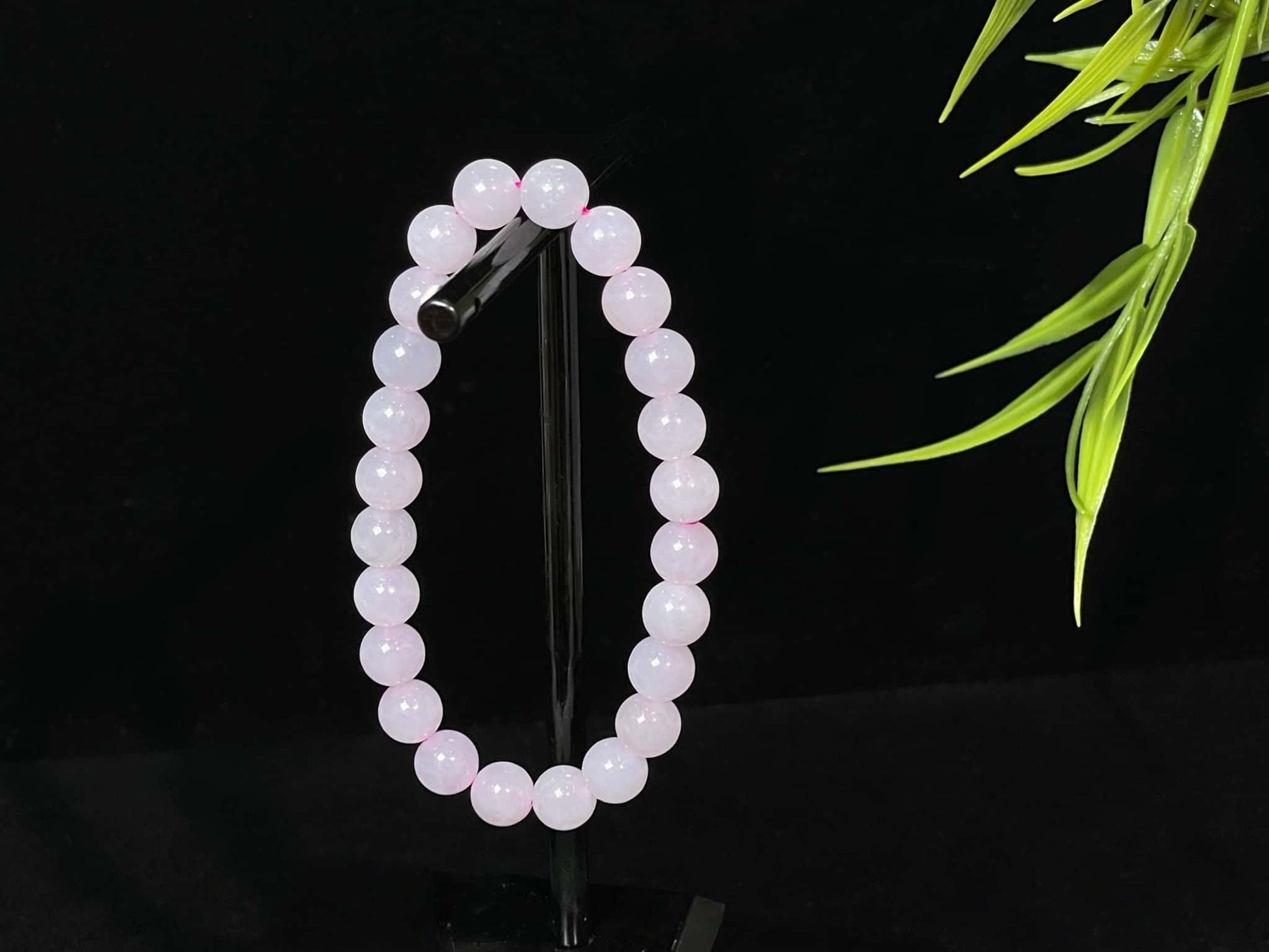 A clear white with pink thread jadeite beads bracelet.