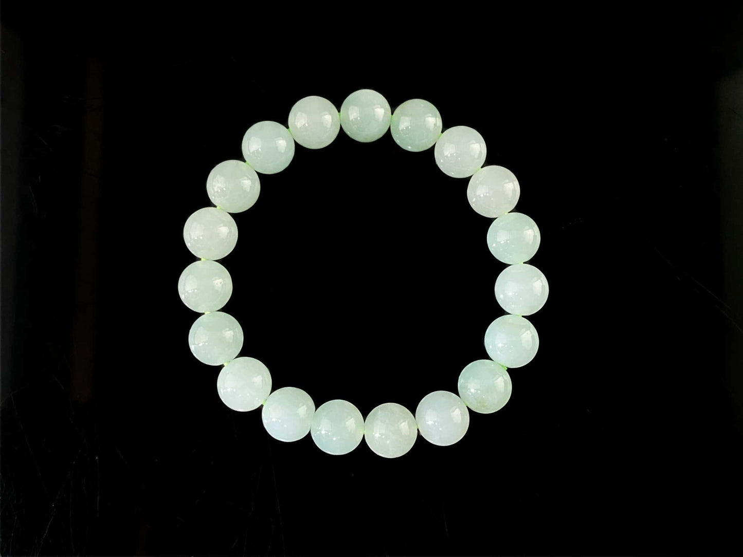 A milky pale green calm jadeite beads bracelet.