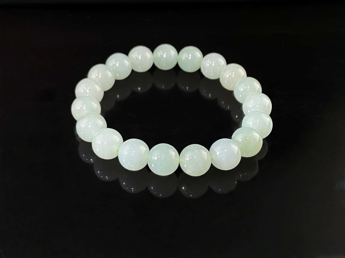 A milky pale green calm jadeite beads bracelet.