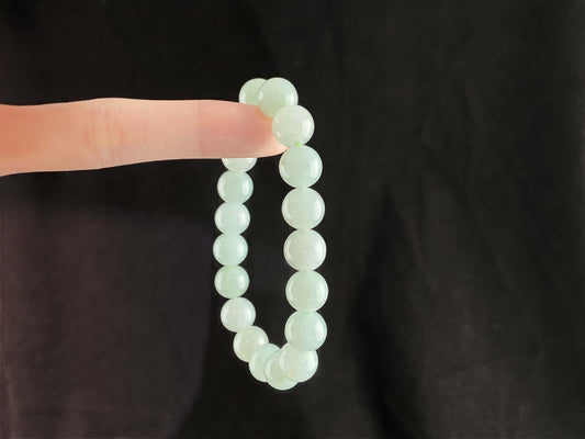 A milky pale green calm jadeite beads bracelet.