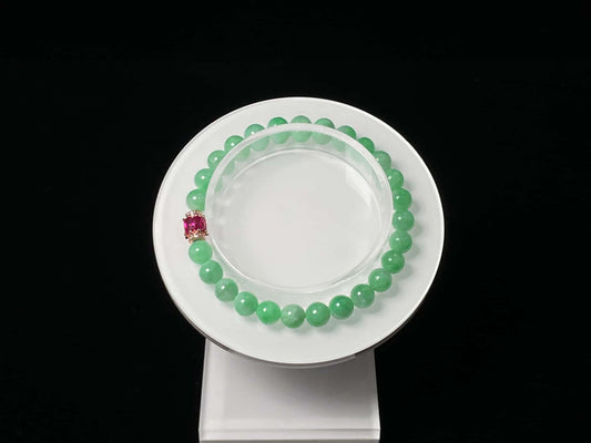 A pale mint and pink spark jadeite beads bracelet.
