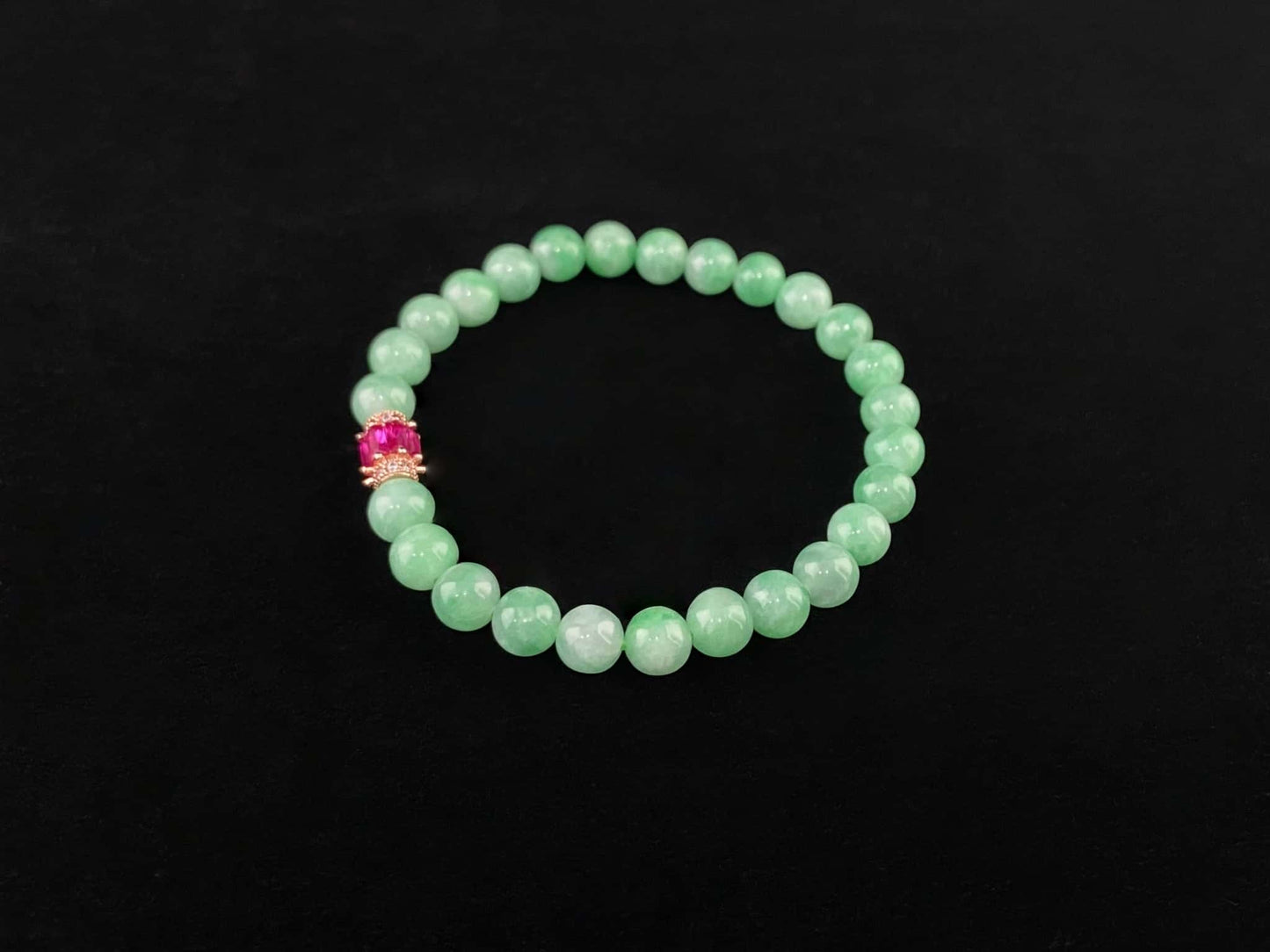 A pale mint and pink spark jadeite beads bracelet.