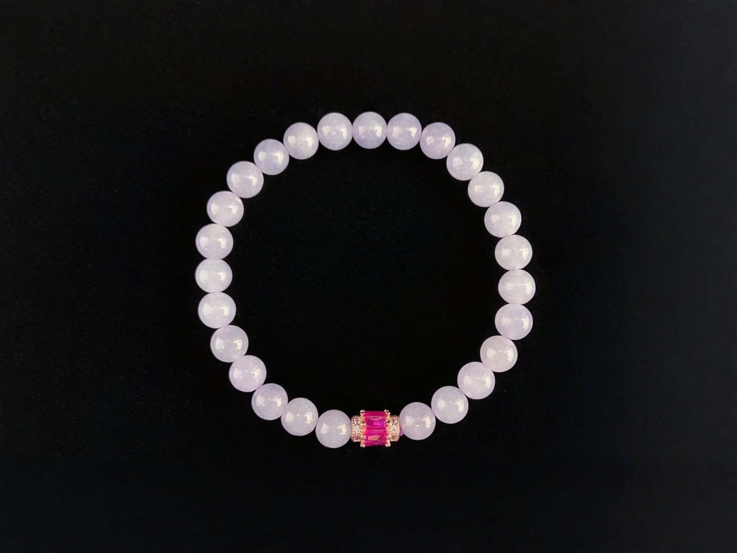 A clear white with pink thread jadeite beads bracelet.