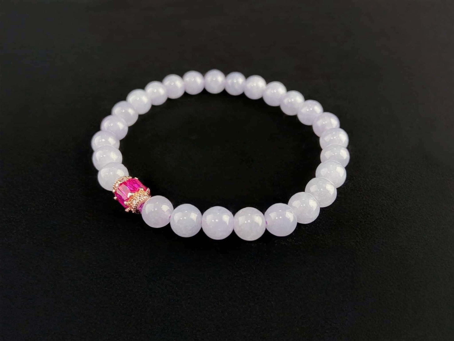 A clear white with pink thread jadeite beads bracelet.
