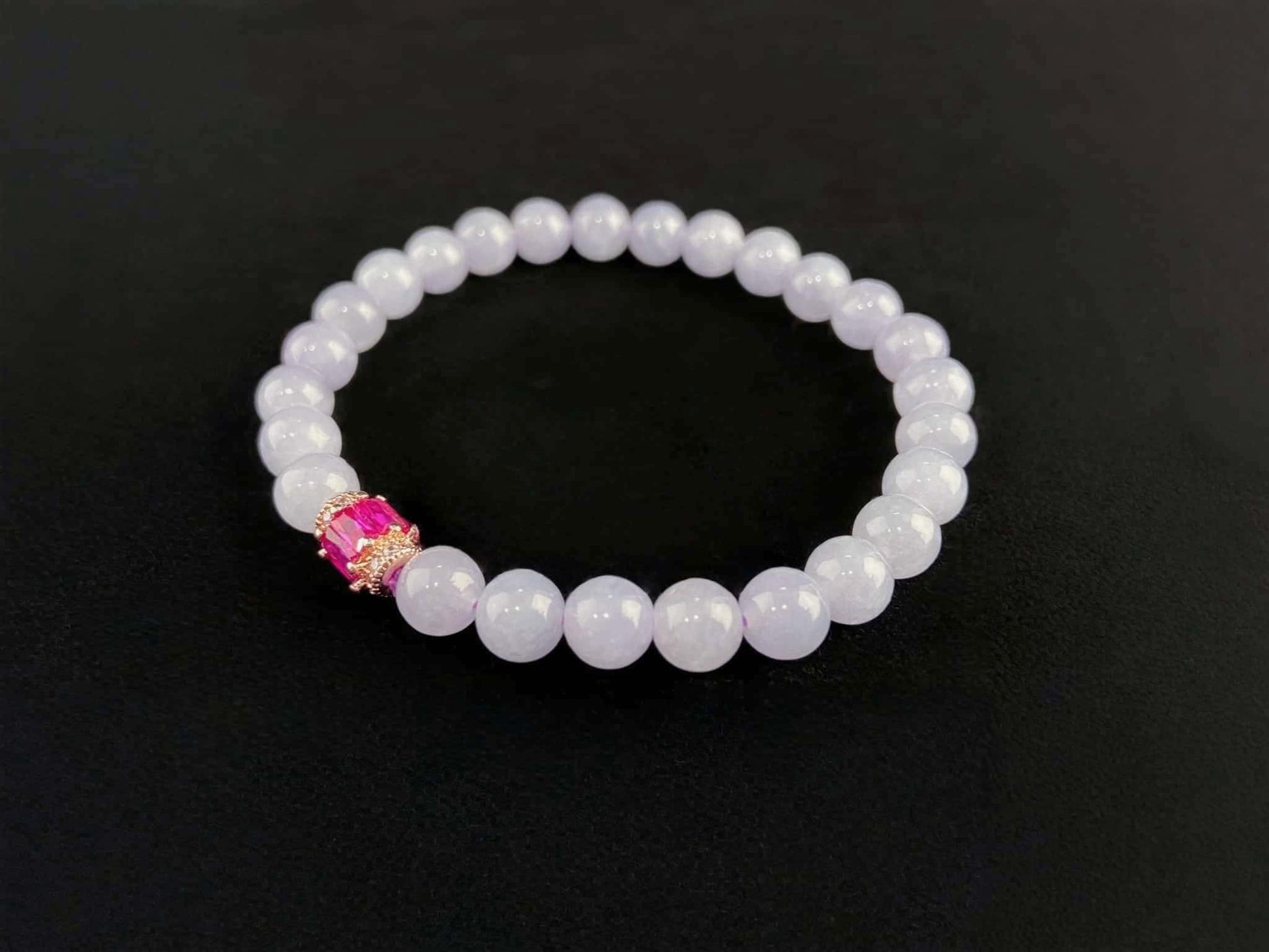 A clear white with pink thread jadeite beads bracelet.