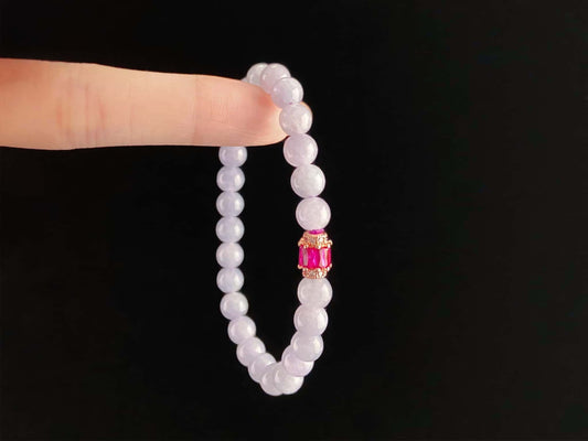 A clear white with pink thread jadeite beads bracelet.