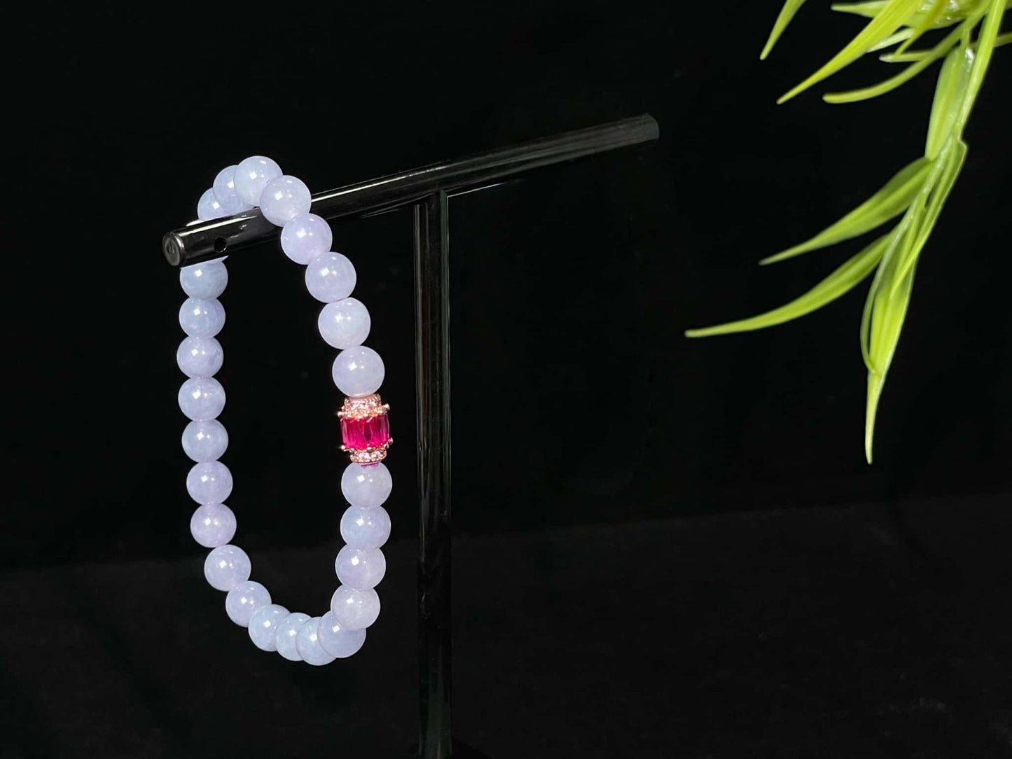 A clear white with pink thread jadeite beads bracelet.