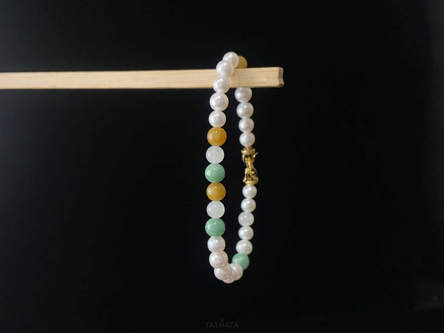 A sunlit mint pearl jadeite beads bracelet.