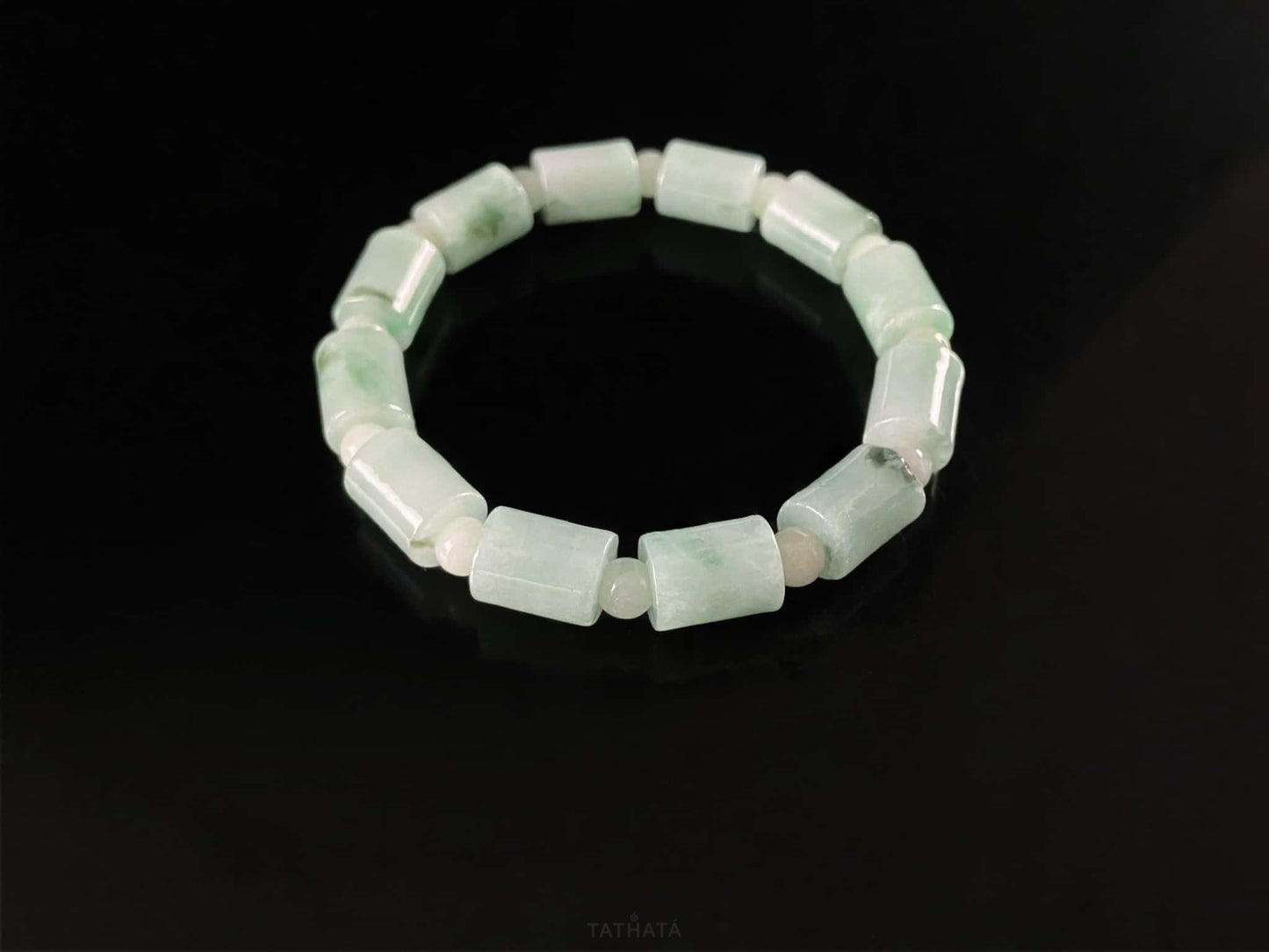 A mint green barrel beads bracelet.