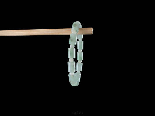 A mint green barrel beads bracelet.