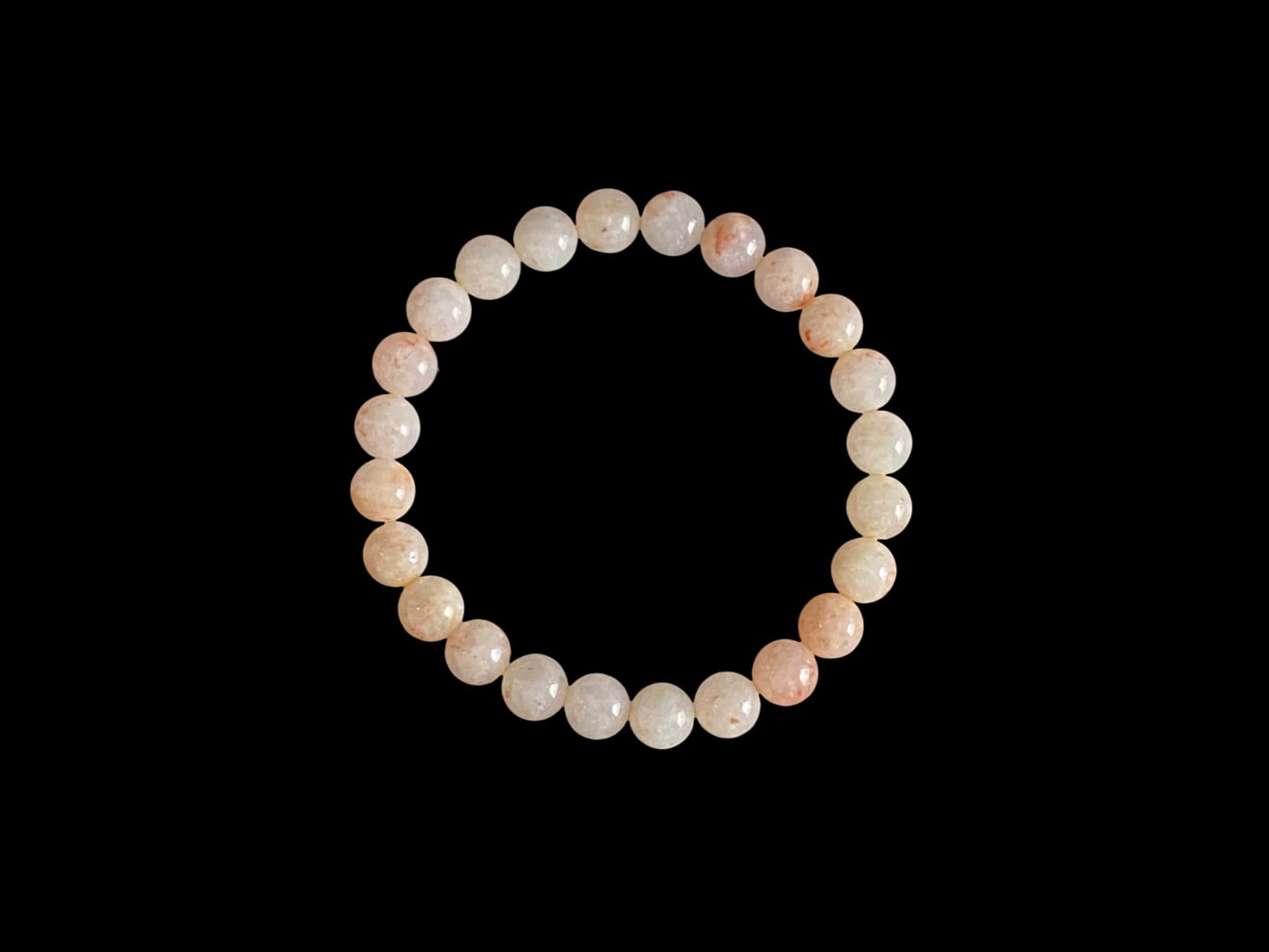 A warm peach tone jadeite beads bracelet.
