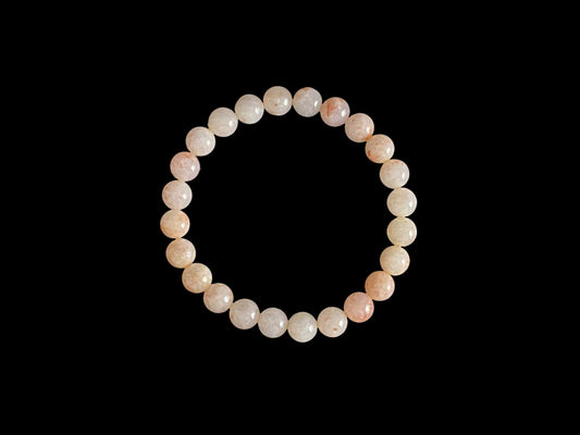 A warm peach tone jadeite beads bracelet.