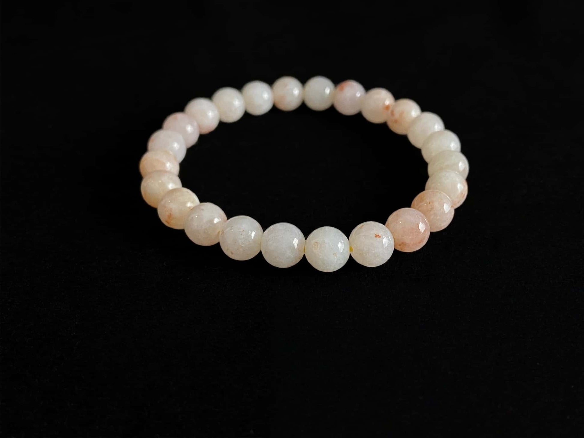 A warm peach tone jadeite beads bracelet.
